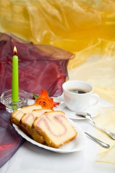 sweet cake on dish with rose and coffee