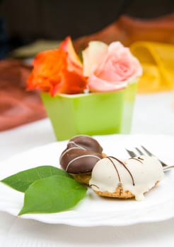 sweet cake on dish with rose and coffee