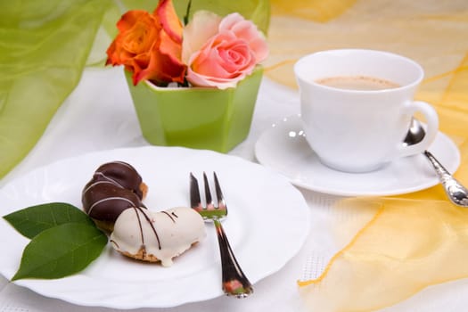 sweet cake on dish with rose and coffee
