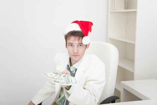 The guy in a Christmas hat gives us money