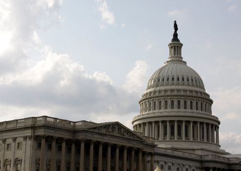 The front of the United States Capitol building, in Washington D.C., against stormy cloud.
