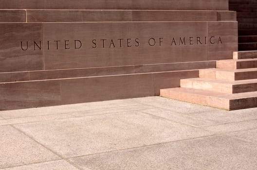 Lettering for the United States of America in a stone wall.