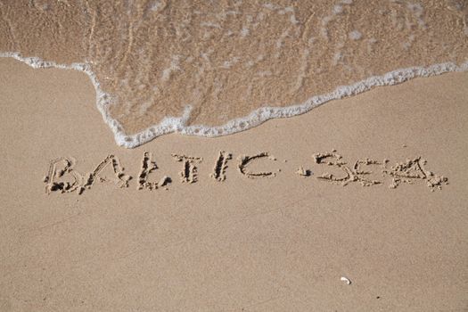 Baltic sea inscription on the coast of sea