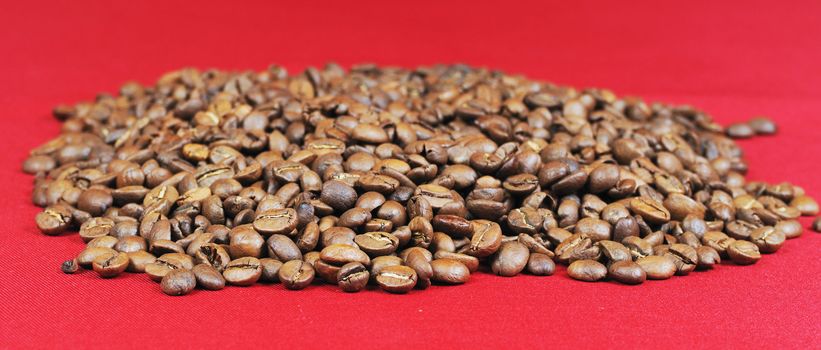 Heap of coffee bean on a red background
