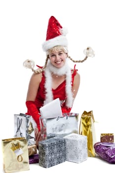 Cute young girl in christmas outfit with presents