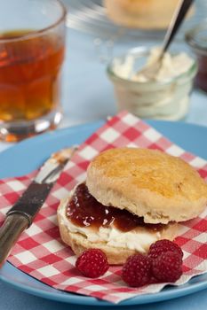 Freshly baked scones with clotted cream and raspberry jam