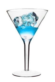 Blue Alcoholic Cocktail in martini glass with ice. Isolated on White Background