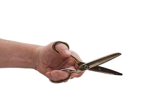 an isolated over white hand hodling a pair of shiny golden antique dress makers scissors.