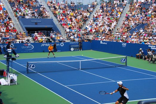 tennis player returning a play at the us open