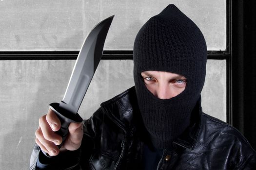 Young man in black with large knife