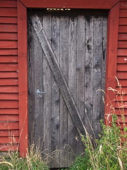 Old weathered wooden country farm barn door