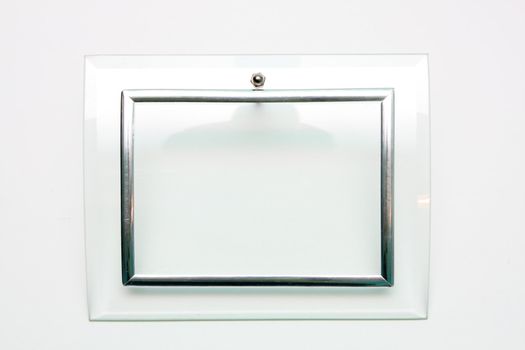 An empty picture frame, metal and glass on a white background