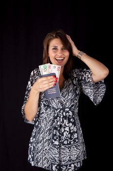 Excited World traveller with three different currencies in her passport