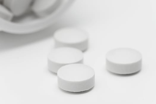 Spilled pills from open prescription medication bottle