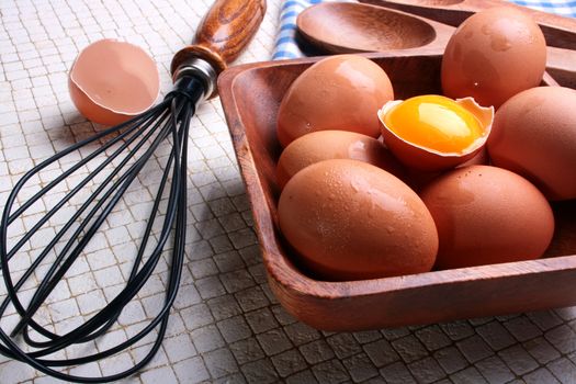 One of components of culinary recipes - the eggs, one of eggs is split and in a shell there is a yolk.