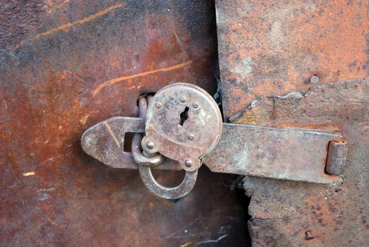 Padlock on old Rusted Metal Door