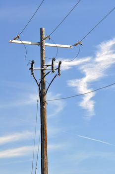 Electrical power pole with associated distribution lines and components.