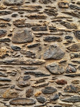 Texture rich stones of a house wall