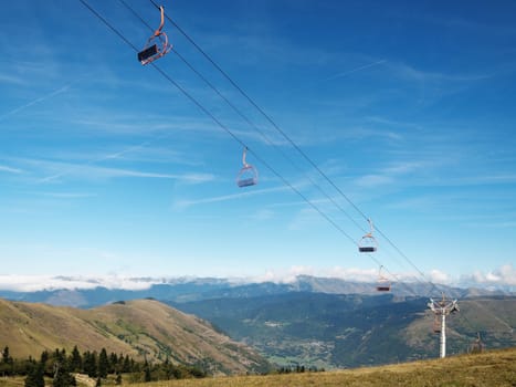  Empty ski lifts during the summer  with pyrenees mountains in the background