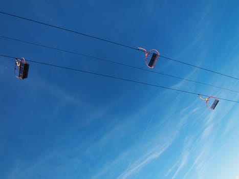 Empty ski lifts during the summer against blue sky with clouds