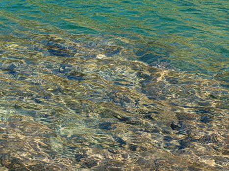 Beautiful crystal clear  water of a high mountain lake with stones