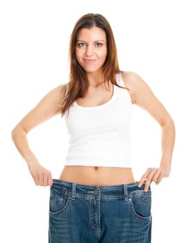 Slim woman pulling oversized jeans. Weight loss concept. Isolated on white