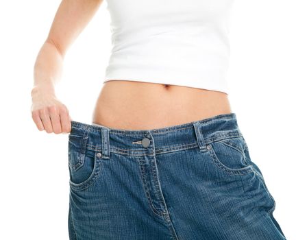 Slim woman pulling oversized jeans. Weight loss concept. Isolated on white