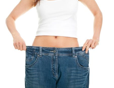 Slim woman pulling oversized jeans. Weight loss concept. Isolated on white