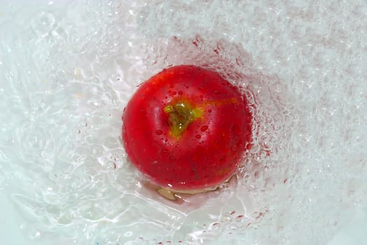 photo of the red apple in water