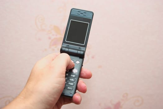 photo of the hand with cellular telephone