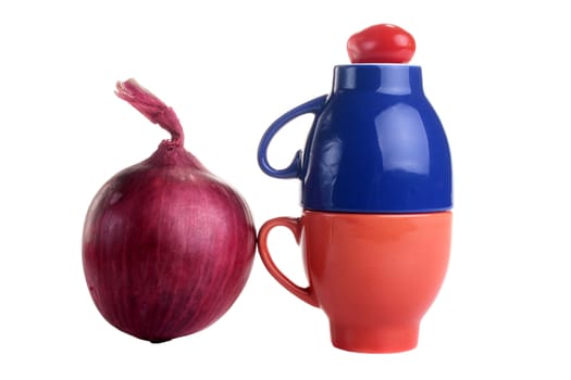 Two cups with a tomato from above and a red onion.