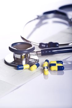 stethoscope, pills and ekg isolated on white background