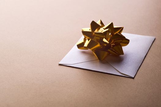 christmas envelope with decorative ribbon on gold background
