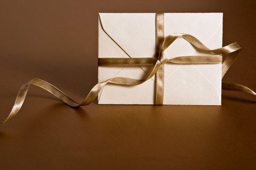 envelope with decorative ribbon on gold background