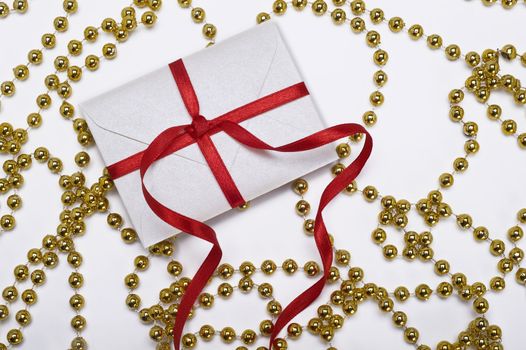 christmas envelope with red ribbon and gold decoration