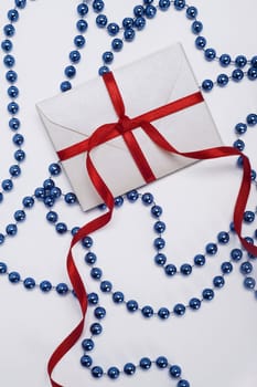 christmas envelope with red ribbon and blue decoration