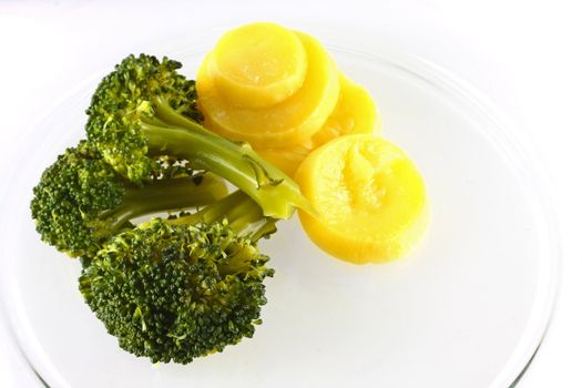 Broccoli and squash on plate, isolated.