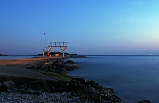 Embankment with colorful construction near the sea