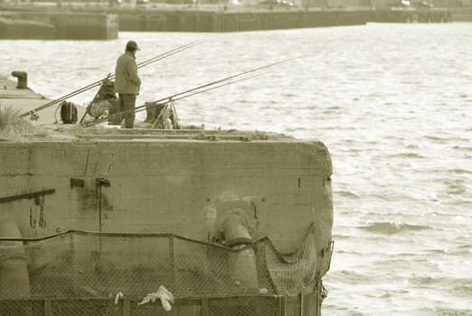 Image of people practicing the sport of sea fishing