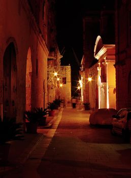 Medieval street by night, in the old city of Mdina in Malta