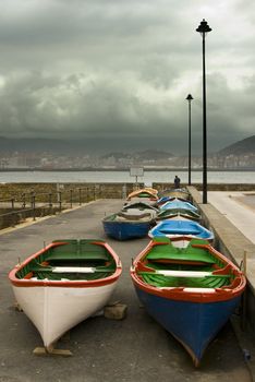 image of some old boats resting in a stormy lead sky