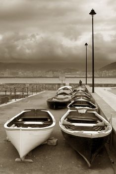 image of some old boats resting in a stormy lead sky