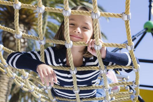 Young Girl on Stomach  Looking Through Rope on Hammock