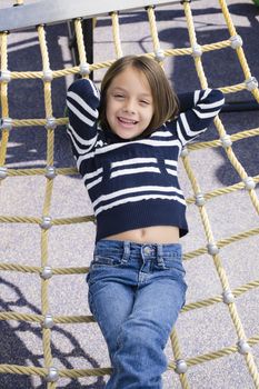 Young  Girl with Hands Behind head Lying on Back on Hammock
