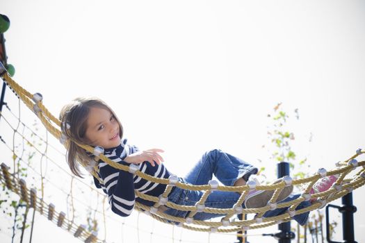 Young Girl Lying on Hammock Smiling To Camera