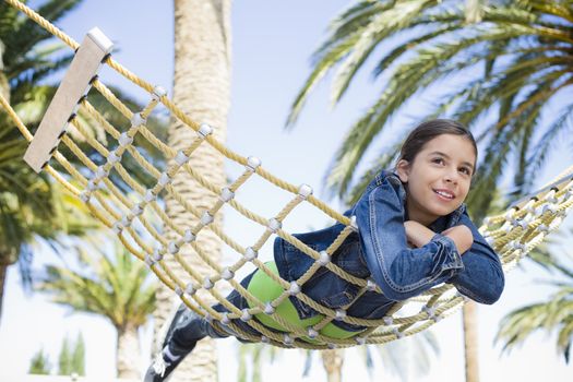 Teenage Girl Lying on Stomach on a Hammock in Park