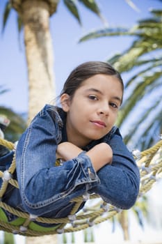 Teenage Girl Lying On Hammock Looking at Camera