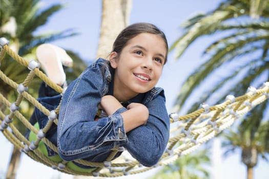 Smiling Teen Girl Lying on Hammock in a Park
