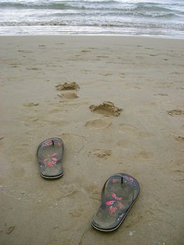          My flip-flops left in the sand while I was having a swim in the Mediterranean Sea.