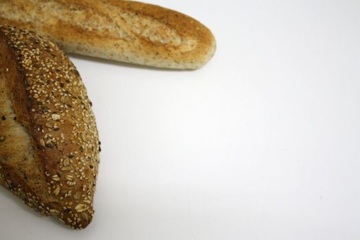 A french baguette and a german bread isolated on a white background, copy space available.